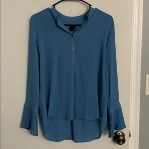 Women’s long sleeve blouse with frilled sleeves.